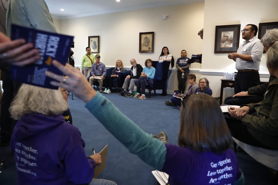 Ricky Hurtado, a Democratic candidate for the North Carolina state house, right, talks to volunteers before they head out to canvass voters, in Mebane, N.C., Sunday, March 8, 2020.