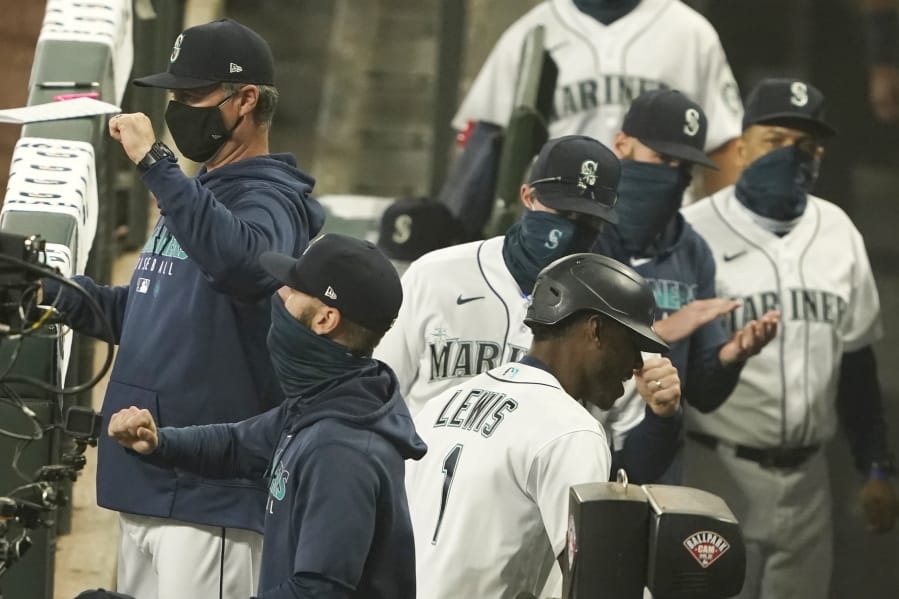 Seattle Mariners&#039; Kyle Lewis (1) is greeted in the dugout after he hit a two-run home run against the Oakland Athletics during the fifth inning of the first baseball game of a doubleheader, Monday, Sept. 14, 2020, in Seattle. (AP Photo/Ted S.