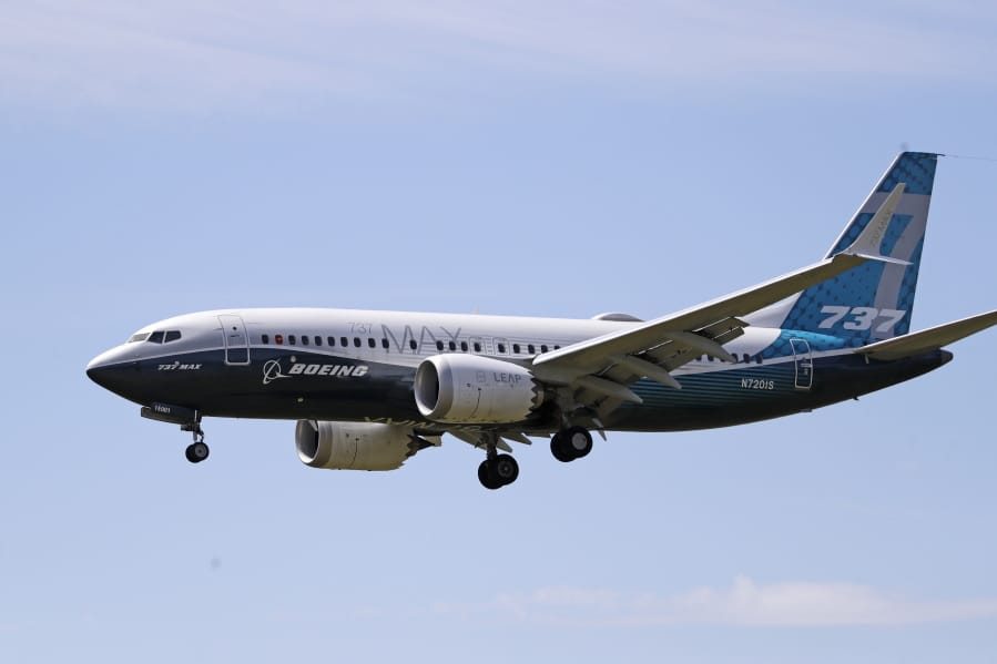 FILE - In this Monday, June 29, 2020, file photo, a Boeing 737 Max jet heads to a landing at Boeing Field following a test flight in Seattle. A U.S. House committee is questioning whether Boeing and the Federal Aviation Administration have recognized problems that caused two deadly 737 Max jet crashes and if either organization will be willing to make significant changes to fix them.