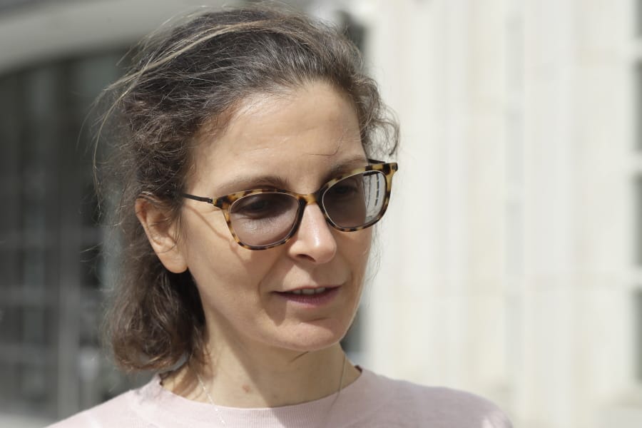 FILE - In this April 8, 2019, file photo, Seagram&#039;s liquor fortune heiress Clare Bronfman leaves Brooklyn Federal Court, in New York. Bronfman, the wealthy benefactor of Keith Raniere, the disgraced leader of a self-improvement group in upstate New York convicted of turning women into sex slaves branded with his initials, will be in court, on Wednesday, Sept. 30, 2020, for sentencing on federal conspiracy charges.