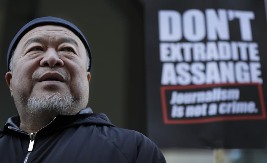 Chinese contemporary artist and activist Ai Weiwei stands with protesters outside the Old Bailey in support of Julian Assange&#039;s bid for freedom during his extradition hearing, in London, Monday, Sept. 28, 2020.