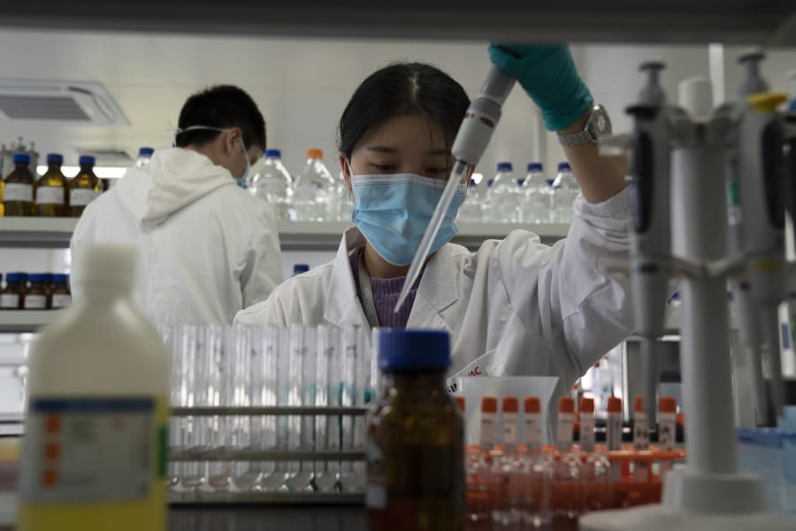 An employee of SinoVac works in a lab at a factory producing its SARS CoV-2 Vaccine for COVID-19 named CoronaVac in Beijing on Thursday, Sept. 24, 2020. SinoVac&#039;s CEO says they have injected 90 percent of its employees and family members, or about 3,000 people, and provided tens of thousands of rounds of CoronaVac to the municipal government of Beijing. It&#039;s a highly unusual move that raises ethical and safety questions, as companies and governments worldwide race to develop a vaccine that will stop the spread of the new coronavirus.