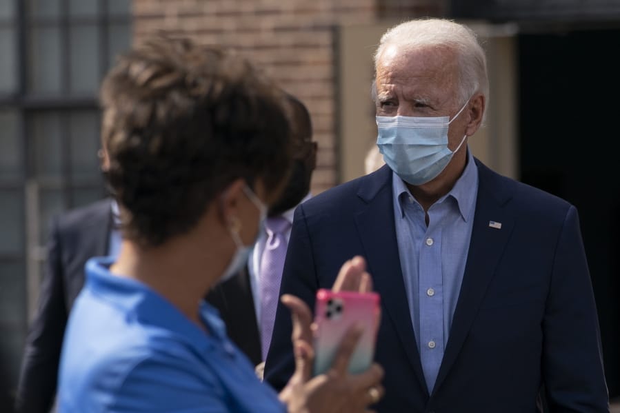 Democratic presidential candidate former Vice President Joe Biden is applauded as he arrives to pose for a photo with union leaders outside the AFL-CIO headquarters in Harrisburg, Pa., Monday, Sept. 7, 2020.