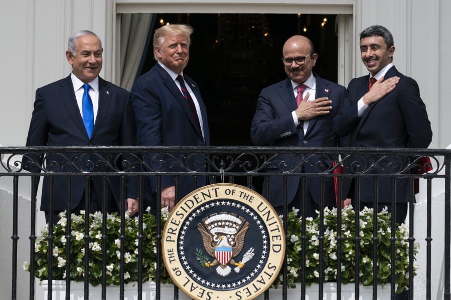 FILE - In this Tuesday, Sept. 15, 2020 file photo, Israeli Prime Minister Benjamin Netanyahu, left, President Donald Trump, Bahrain Foreign Minister Khalid bin Ahmed Al Khalifa and United Arab Emirates Foreign Minister Abdullah bin Zayed al-Nahyan react on the Blue Room Balcony after signing the Abraham Accords during a ceremony on the South Lawn of the White House in Washington. Jewish American voters have leaned Democratic for decades, but the GOP is still eyeing modest gains with the constituency in states where President Donald Trump could reap major benefits with even small improvements over his performance in 2016.
