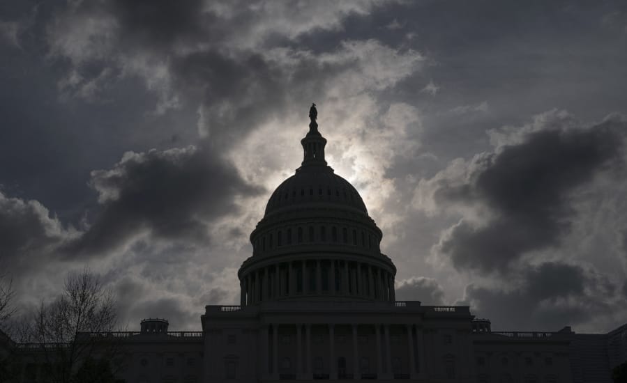 FILE - In this April 12, 2019, file photo, morning clouds cover Capitol Hill in Washington, as Congress leaves for a two week recess. Philanthropy is stepping in to fund U.S. elections during the coronavirus pandemic. This comes after Congress has failed to approve additional funding to help election officials adjust to an expected avalanche of mail ballots and need to sanitize polling places. (AP Photo/J.