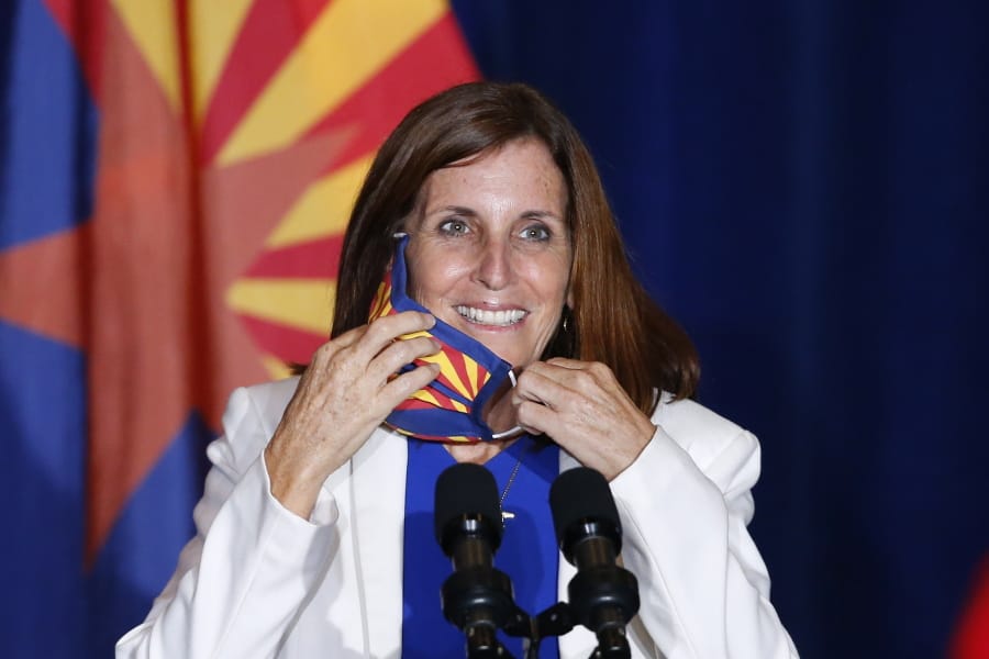 FILE - In this Tuesday, Aug. 11, 2020 file photo, Sen. Martha McSally, R-Ariz., smiles as she removes her face covering to speak prior to Vice President Mike Pence arriving to speak at the &quot;Latter-Day Saints for Trump&quot; coalition launch event in Mesa, Ariz. McSally has suggested that supporters could &quot;fast a meal&quot; to donate to the Arizona Republican&#039;s campaign as she fights to fend off a tough challenge from Democrat Mark Kelly in the November 2020 election. (AP Photo/Ross D.