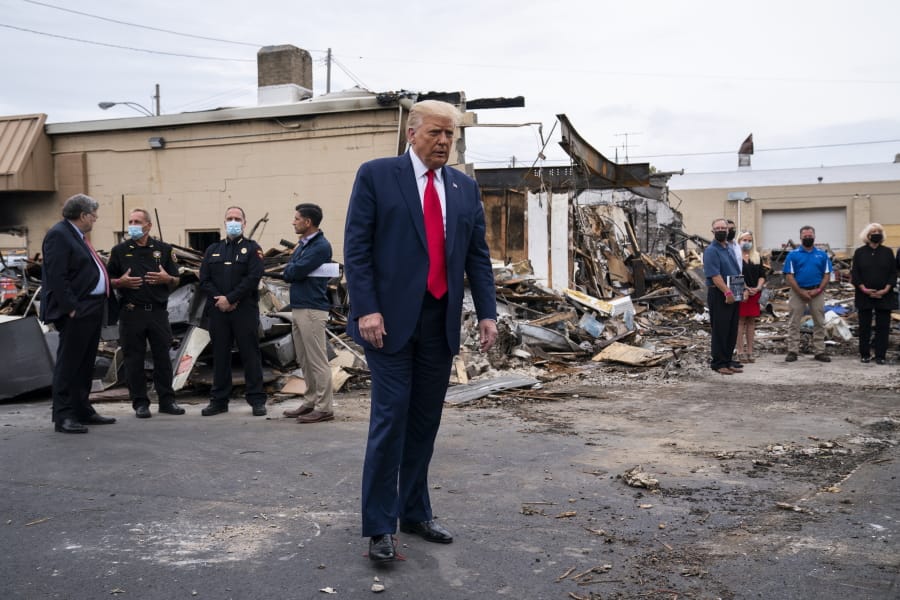 FILE - In this Sept. 1, 2020 file photo, President Donald Trump tours an area damaged during demonstrations after a police officer shot Jacob Blake in Kenosha, Wis. Wisconsin Democrats, stung by President Trump&#039;s narrow win four years ago, are confident the lessons they learned will ensure he doesn&#039;t do it again. But Republicans say civil unrest that followed a police shooting in Kenosha, and Trump&#039;s &quot;law and order&quot; message, will help him win over the crucial white suburban voters he needs to capture a second term.
