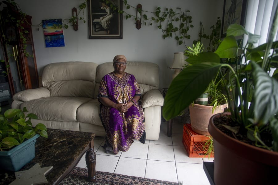 Yochebed Israel, a certified nursing assistant, poses for a portrait inside her Tampa, Fla. apartment on Monday, Aug. 17, 2020. Israel&#039;s landlord tried to evict her in violation of the CARES Act after she fell behind on rent after contracting COVID-19.