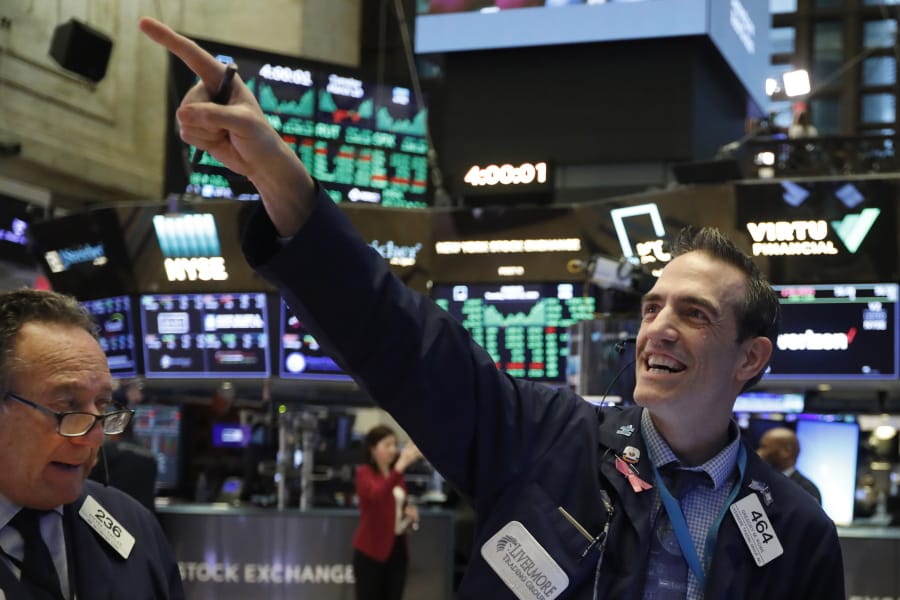 FILE - In this March 10, 2020, file photo, traders Steven Kaplan, left, and Gregory Rowe react at the closing on the floor of the New York Stock Exchange. Wall Street is opening slightly higher, Tuesday, Sept. 22, 2020, as markets recover from steep losses Monday.