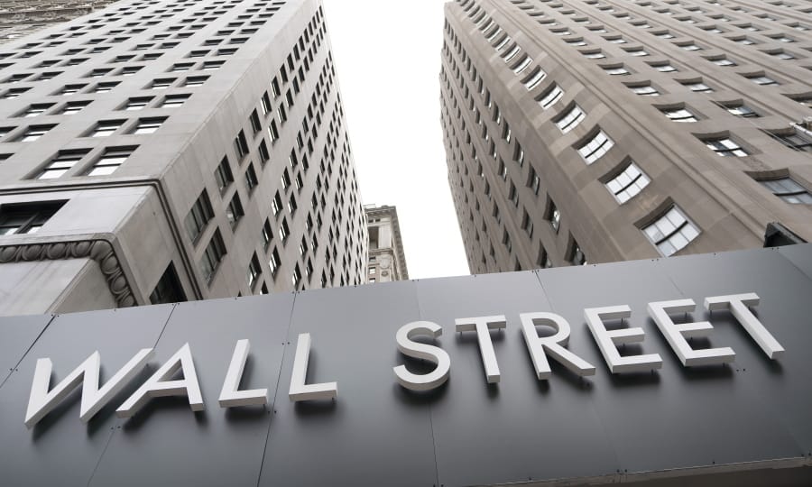 FILE - In this Aug. 31, 2020 file photo, buildings line Wall Street, in New York. Stocks are opening higher on Wall Street Thursday, Sept. 10 as the market claws back some more of the ground it lost in a three-day slump that snapped a day earlier.