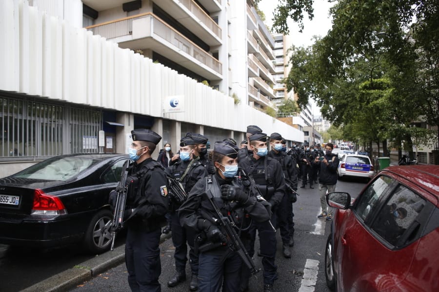 French police officers patrol the area after a knife attack near the former offices of satirical newspaper Charlie Hebdo, Friday Sept. 25, 2020 in Paris. Paris police say they have arrested a man suspected of a knife attack that wounded at least two people near the former offices of satirical newspaper Charlie Hebdo. Police initially thought there were two attackers but now say there was only one.