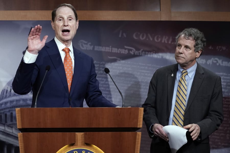 FILE - In this Wednesday, Jan. 15, 2020 file photo, Senate Finance Committee ranking member Ron Wyden, D-Ore., speaks during a news conference at the Capitol in Washington, about a U.S. China trade agreement, accompanied by Sen. Sherrod Brown, D-Ohio, right. On Friday, Sept. 25, 2020, Sens. Wyden and Brown said the government needs to ban the import of products made with child or forced labor after an Associated Press investigation found widespread exploitation in the palm oil industry, from debt bondage to outright slavery. (AP Photo/J.