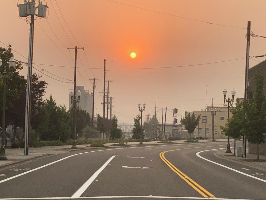 The sun sets through wildfire smoke in downtown Vancouver on Sept.7, 2020 as strong east winds buffeted Clark County.
