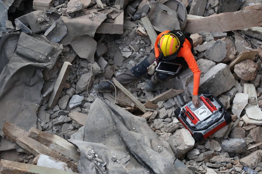A Chilean rescuer uses a sound tracking machine at the site of a collapsed building in last month&#039;s massive explosion after getting signals there may be a survivor under the rubble in Beirut, Lebanon, Early Friday, Sept. 4, 2020. A pulsing signal was detected Thursday from under the rubble of a Beirut building that collapsed during the horrific port explosion in the Lebanese capital last month, raising hopes there may be a survivor still buried there.