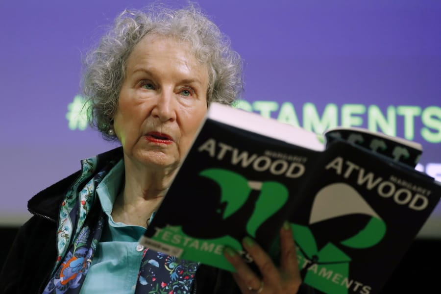 FILE - In this Sept. 10, 2019, file photo, Canadian author Margaret Atwood holds a copy of her book &quot;The Testaments,&quot; during a news conference in London. Atwood, whose sweeping body of work includes &quot;The Handmaid&#039;s Tale,&quot; depicting a nightmarish future for the United States, is this year&#039;s winner of a lifetime achievement award celebrating literature&#039;s power to foster peace, social justice and global understanding, officials of the Dayton Literary Peace Prize officials announced Monday, Sept. 14, 2020.