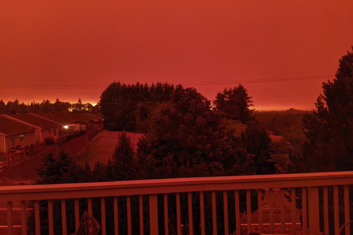 This photo taken from the home of Russ Casler in Salem, Ore., shows the smoke-darkened sky well before sunset at around 5 p.m., Tuesday, Sept. 8, 2020.  Strong winds and high temperatures continued to fuel catastrophic fires in many parts of Oregon on Wednesday, forcing thousands of people to flee from their homes and making for poor air quality throughout the West. Huge wildfires also continued to grow in neighboring Washington state.