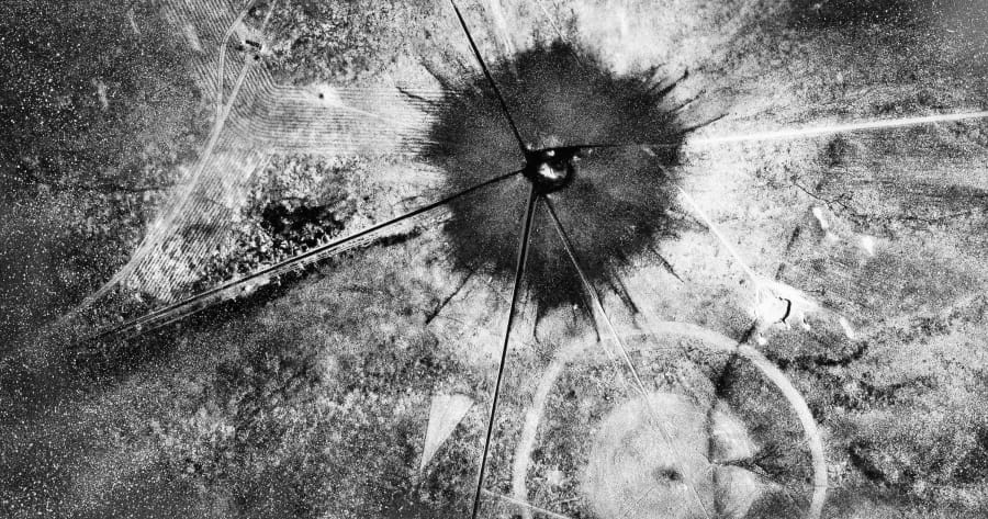 FILE - This July 16, 1945 photo, shows an aerial view after the first atomic explosion at Trinity Test Site, N.M. A defense spending bill pending in Congress includes an apology to New Mexico, Nevada, Utah and other states affected by nuclear testing over the decades, but communities downwind from the first atomic test in 1945 are still holding out for compensation amid rumblings about the potential for the U.S. to resume nuclear testing.