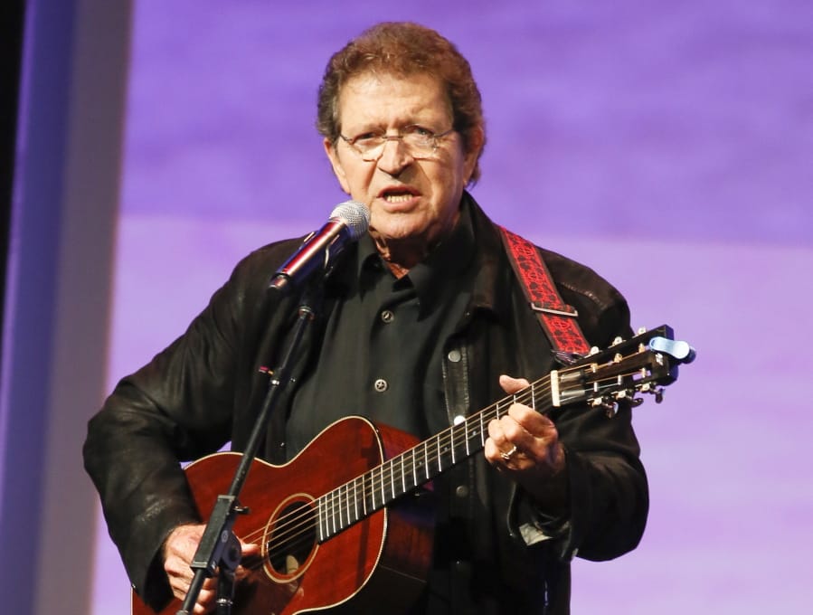 FILE - Musician Mac Davis performs at the Texas Film Awards in Austin, Texas on March 6, 2014. Davis, a country star and Elvis songwriter,   died on Tuesday, Sept. 29, 2020 after heart surgery. He was 78. Davis started his career writing hits for Presley, including &quot;A Little Less Conversation&quot; and &quot;In the Ghetto.&quot; The Lubbock, Texas-native had a varied career over the years as a singer, actor and TV host and was inducted into the Songwriters Hall of Fame in 2006.
