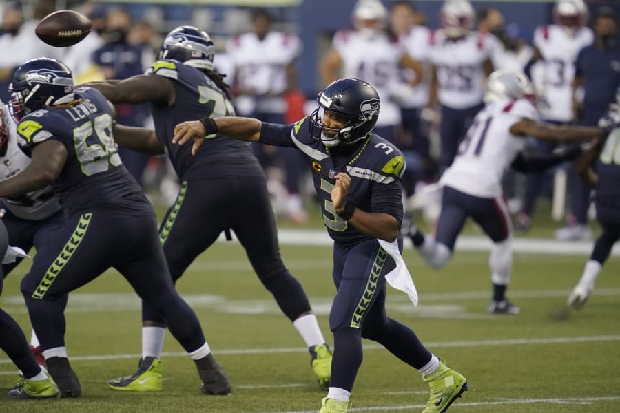 Seattle Seahawks quarterback Russell Wilson passes against the New England Patriots during the second half of an NFL football game, Sunday, Sept. 20, 2020, in Seattle.