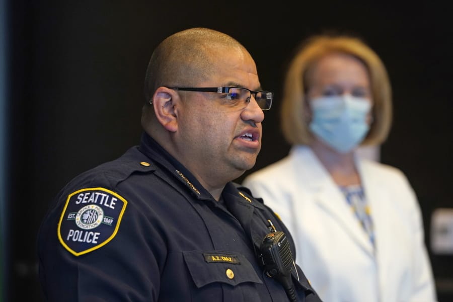 Interim Seattle Police Chief Adrian Diaz, left, addresses a news conference about changes being made at the department as Mayor Jenny Durkan looks on Wednesday, Sept. 2, 2020, in Seattle. The Seattle Police Department is reassigning 100 officers from specialty units to patrol in hopes of increasing community engagement and speeding up 911 responses. Durkan and Diaz described the changes as part of the city&#039;s broader efforts to reimagine the role of officers in response to anti-racism and anti-police protests that have gripped the nation following the killing of George Floyd in Minneapolis.