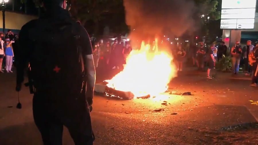 In this image taken from video a mattress burns in the street near the Portland Police Bureau&#039;s North Precinct Sunday night, Sept. 6, 2020, in Portland, Ore. Protesters have gathered for more than 100 days following the death of George Floyd in Minneapolis.