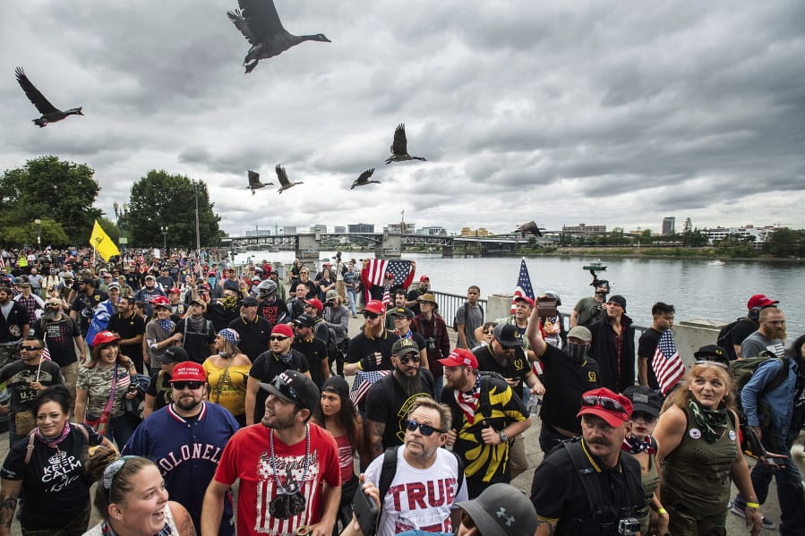 FILE - In this Aug. 17, 2019, file photo, members of the Proud Boys and other right-wing demonstrators march along the Willamette River during a rally in Portland, Ore. Portland has denied a permit for a Saturday rally planned by the right-wing group Proud Boys. The Portland Parks &amp; Recreation Bureau said Wednesday, Sept. 23, 2020, that the group&#039;s estimated crowd size of 10,000 people was too big under coronavirus safety measures.