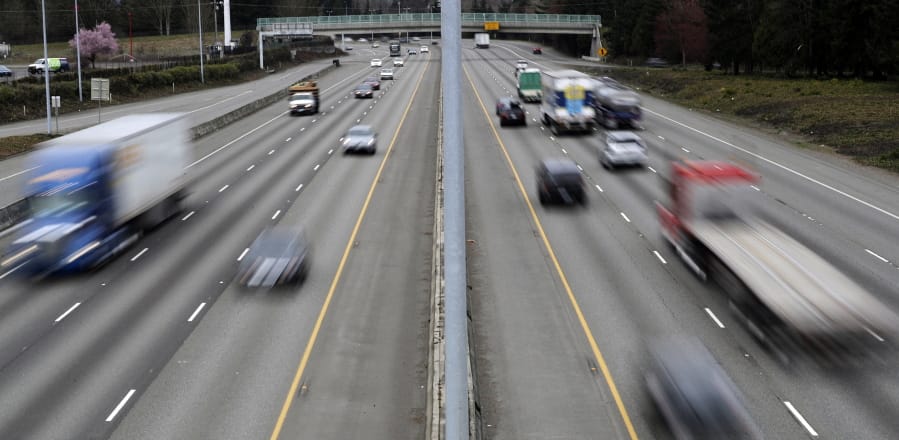 FILE - In this Monday, March 25, 2019, file photo, cars and trucks travel on Interstate 5 near Olympia, Wash. A new study says that safety features such as automatic emergency braking and forward collision warnings could prevent more than 40% of crashes in which semis rear-end other vehicles. (AP Photo/Ted S.