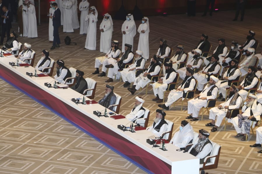 Taliban negotiator Abbas Stanikzai, fifth right, with his delegation attend the opening session of the peace talks between the Afghan government and the Taliban in Doha, Qatar, Saturday, Sept. 12, 2020.