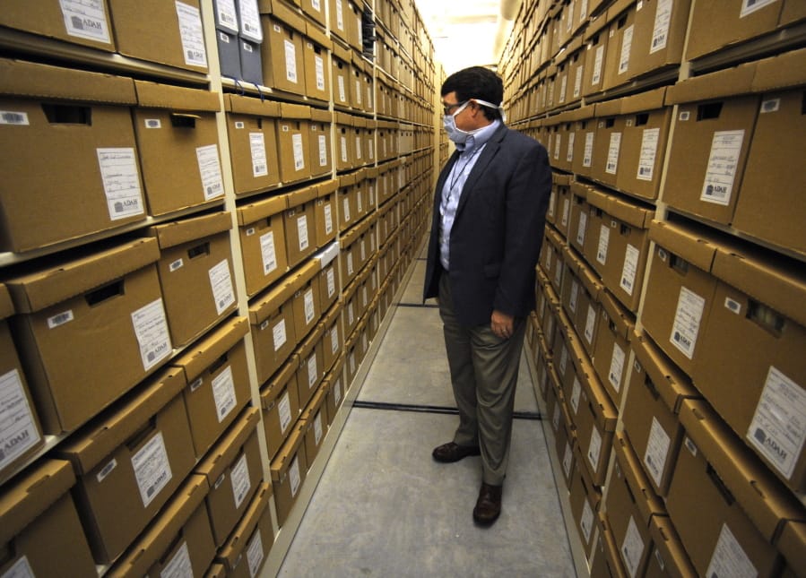 Steve Murray, director of the Alabama Department of Archives and History, looks through boxes containing archival materials in Montgomery, Ala., on Thursday, Aug. 13, 2020. Murray and other current leaders of the agency are confronting the early legacy of the department, which once embraced the &quot;lost cause&quot; version of Civil War history that diminished the role of slavery and portrayed the Southern cause as noble.