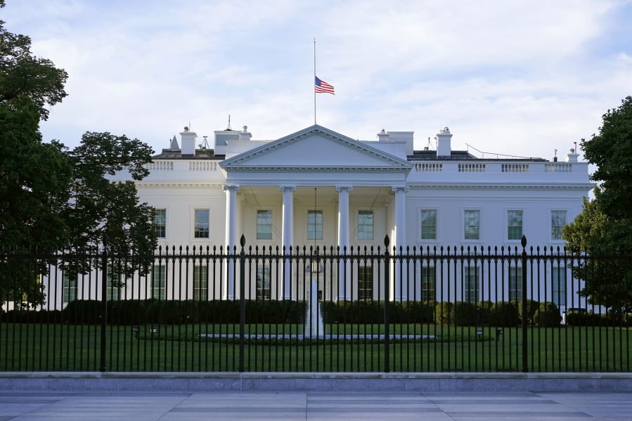 FILE - In this Saturday, Sept. 19, 2020, file photo, an American flag flies at half-staff over the White House in Washington. A woman suspected of sending an envelope containing the poison ricin, which was addressed to White House, has been arrested at the New York-Canada border.