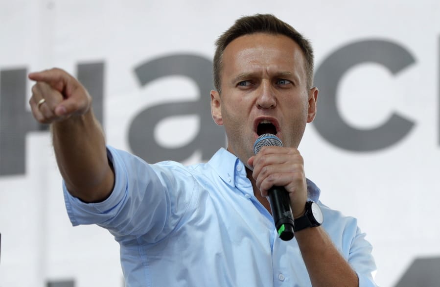 FILE - In this July 20, 2019, file photo, Russian opposition activist Alexei Navalny gestures while speaking to a crowd during a political protest in Moscow, Russia. The German hospital treating Russian opposition leader Alexei Navalny says he has been taken out of an induced coma and is responsive. German experts say Navalny, who fell ill Aug. 20 on a domestic flight in Russia, was poisoned with a substance belonging to the Soviet-era nerve agent Novichok.