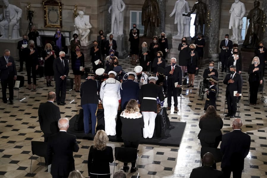 A joint services military team places the flag-draped casket of Justice Ruth Bader Ginsburg as she lies in state at National Statuary Hall in the U.S. Capitol on Friday, Sept. 25, 2020. Ginsburg died at the age of 87 on Sept. 18 and is the first women to lie in state at the Capitol.