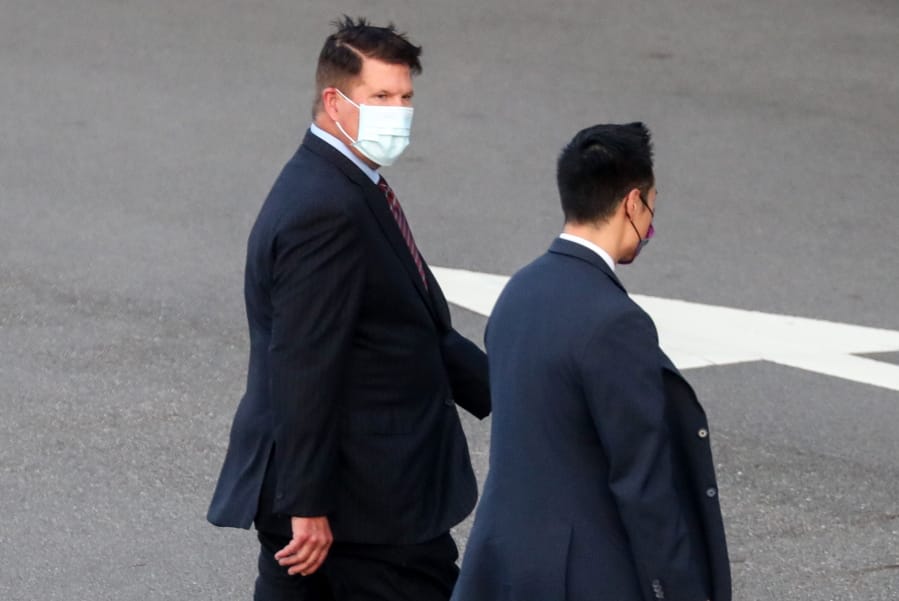 FILE - In this Sept. 17, 2020, file photo,  U.S. Undersecretary of State Keith Krach, walks away after disembarking from a plane upon arrival at an airforce base in Taipei. Taiwan. The second U.S. high level envoy to visit Taiwan in two months began a day of closed-door meetings Friday, as China conducted military drills near the Taiwan Strait after threatening retaliation.
