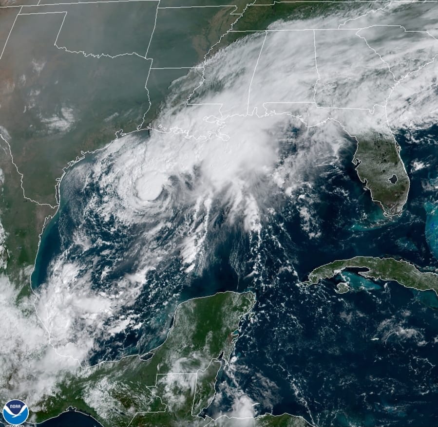 This GOES-16 GeoColor satellite image taken Saturday, Sept. 19, 2020, and provided by NOAA, shows Tropical Storm Beta, center,  in the Gulf of Mexico.  A hurricane watch is in effect Saturday for coastal Texas as Tropical Storm Beta gains strength.  A storm surge watch and a tropical storm watch are also in effect for the area during an exceptionally busy Atlantic hurricane season.