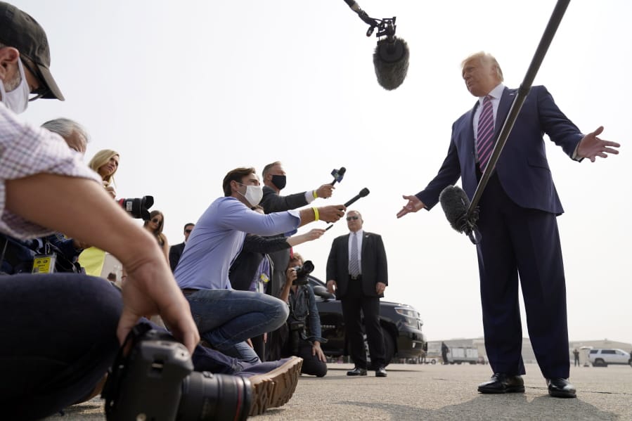 President Donald Trump speaks to reporters as he arrives at Sacramento McClellan Airport, in McClellan Park, Calif., on Monday, for a briefing on wildfires.