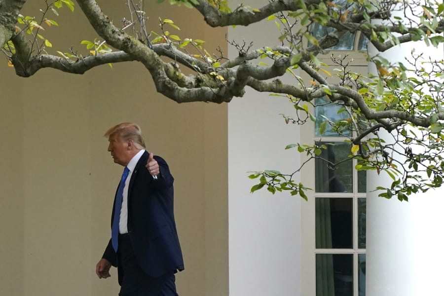 President Donald Trump gestures to members of the press as he walks to the Oval Office of the White House after visiting the Supreme Court to pay respects to Justice Ruth Bader Ginsburg, Thursday, Sept. 24, 2020, in Washington.
