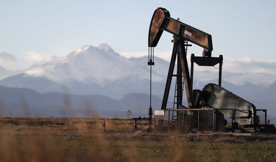 FILE - This Dec. 22, 2018, file photo shows a pump jack over an oil well along Interstate 25 near Dacono, Colo. Federal courts have delivered a string of rebukes to the Trump administration over what they found were failures to protect the environment and address climate change as it promotes fossil fuel interests and the extraction of natural resources from public lands.
