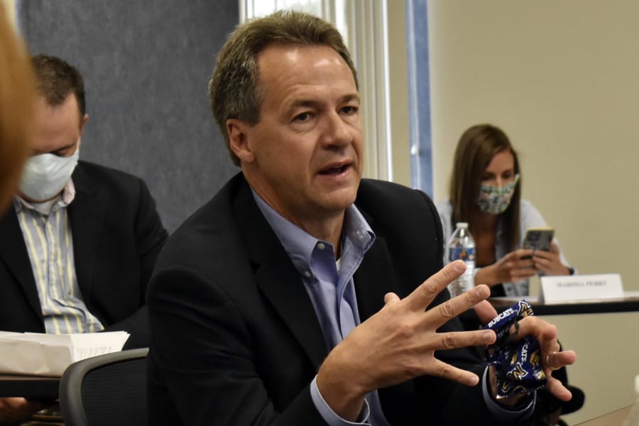 Montana Gov. Steve Bullock speaks to members of the business community in Billings, Mont., on July 24, 2020. The Democratic governor is asking a federal judge to oust the Trump administration official responsible for overseeing more than quarter-billion acres of public lands.