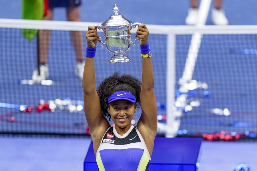 Naomi Osaka, of Japan, holds up the championship trophy after defeating Victoria Azarenka, of Belarus, in the women&#039;s singles final of the US Open tennis championships, Saturday, Sept. 12, 2020, in New York.