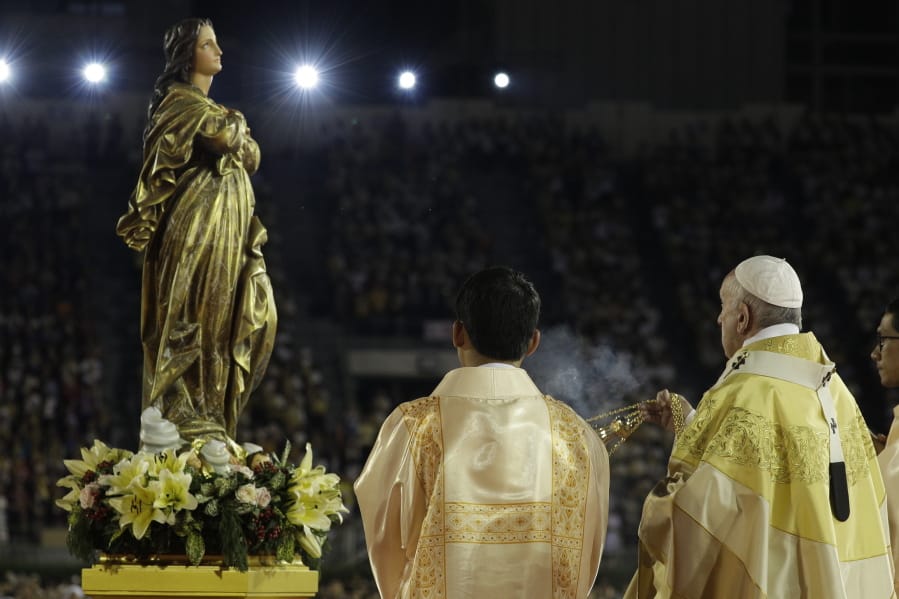 FILE - In this Nov. 21, 2019 file photo, Pope Francis blesses a statue of the Mother Mary as he celebrates Mass at the National Stadium, in Bangkok, Thailand. Pope Francis is giving his blessing to a new Vatican think tank that is seeking to prevent the Mafia and organized crime groups from exploiting the image of the Virgin Mary for their own illicit ends.