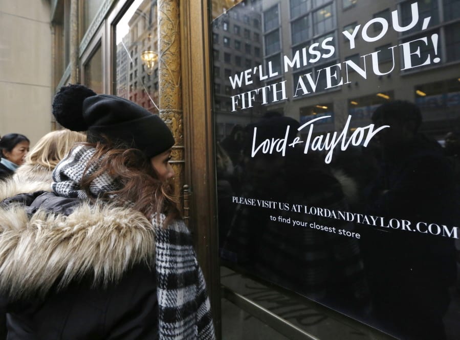 Women peer in the front door of Lord &amp; Taylor&#039;s flagship Fifth Avenue store on Jan. 2, 2019, which closed for good,  in New York. A slew of once-beloved brands from Lord &amp; Taylor to Ann Taylor have filed for Chapter 11 since the pandemic.