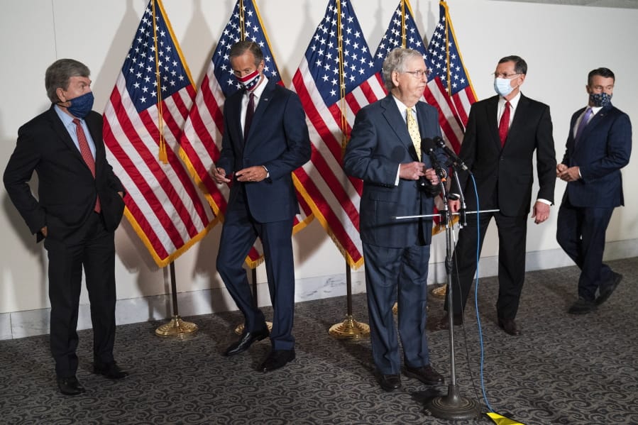 Senate Majority Leader Mitch McConnell of Ky., center, approaches the microphones accompanied by, from left, Sen. Roy Blunt, R-Mo., Sen. John Thune, R-S.D., Sen. John Barrasso, R-Wyo., and Sen. Todd Young, R-Ind., at the start of a news conference, Wednesday, Sept. 9, 2020, on Capitol Hill in Washington.