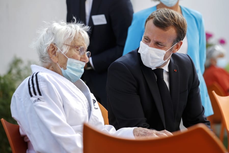 French President Emmanuel Macron, right, talks to a resident at the &#039;La Bonne Eure&#039; nursing home in Bracieux, central France, Tuesday, Sept. 22, 2020. For the first time in months, virus infections and deaths in French nursing homes are on the rise again.