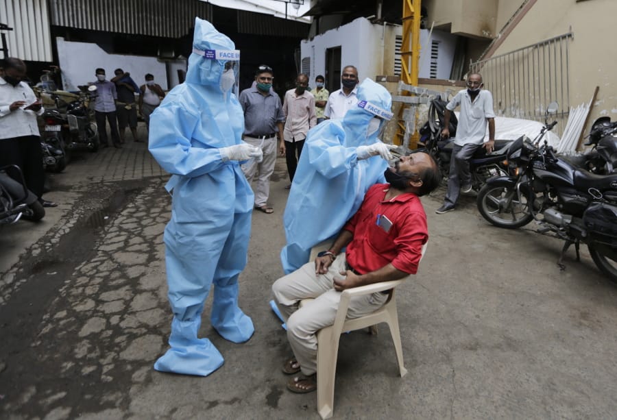A health worker takes a nasal swab sample to test for COVID-19 in Ahmedabad, India, Friday, Sept. 11, 2020. India&#039;s coronavirus cases are now the second-highest in the world and only behind the United States.
