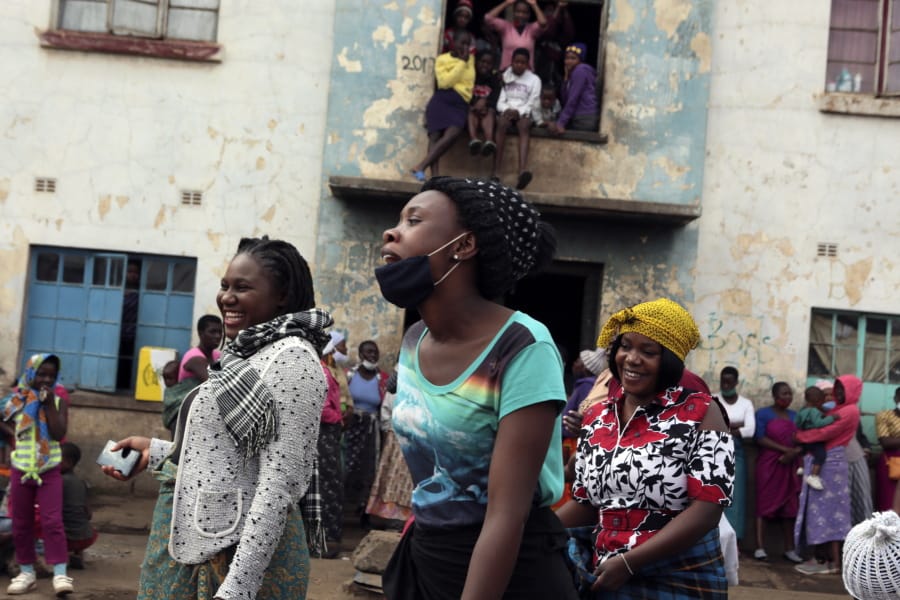 Women share a light moment while attending a social gathering in a poor neighbourhood in Mbare, Harare, Friday, Sept,18, 2020. As Zimbabwe&#039;s coronavirus infections decline, strict lockdowns designed to curb the disease are being replaced by a return to relatively normal life. The threat has eased so much that many people see no need to be cautious, which has invited complacency.