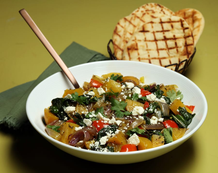Grilled golden beets center a fall salad that makes a colorful dinner, with sauteed beet greens, red onions, bell pepper, herbs and crumbled feta.