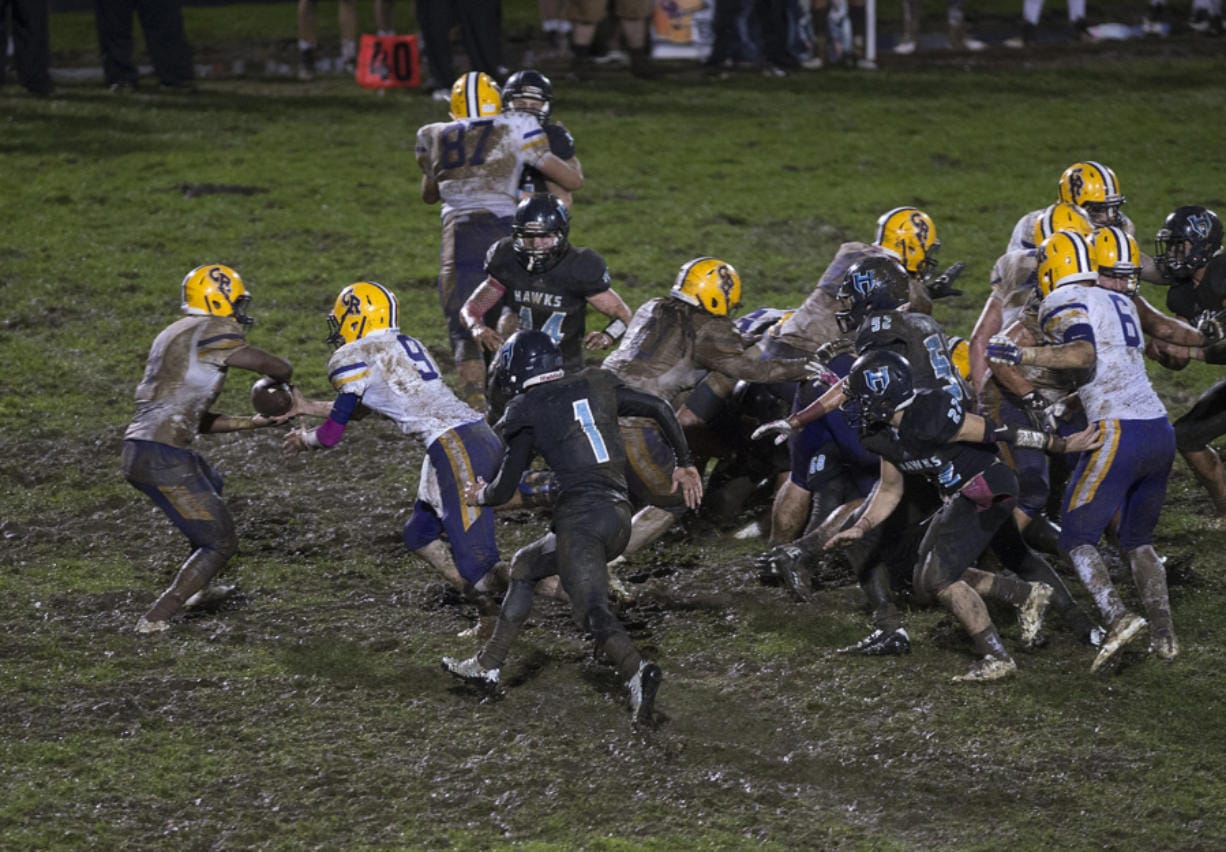 Columbia River and Hockinson play through muddy conditions late in the fourth quarter at Hockinson High School on Friday night, Oct. 14, 2016.