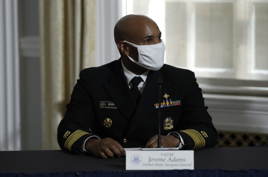 U.S. Surgeon General Vice Admiral Jerome Adams participates with President Donald Trump in a roundtable on donating plasma at the American Red Cross National Headquarters  in Washington on July 30, 2020.