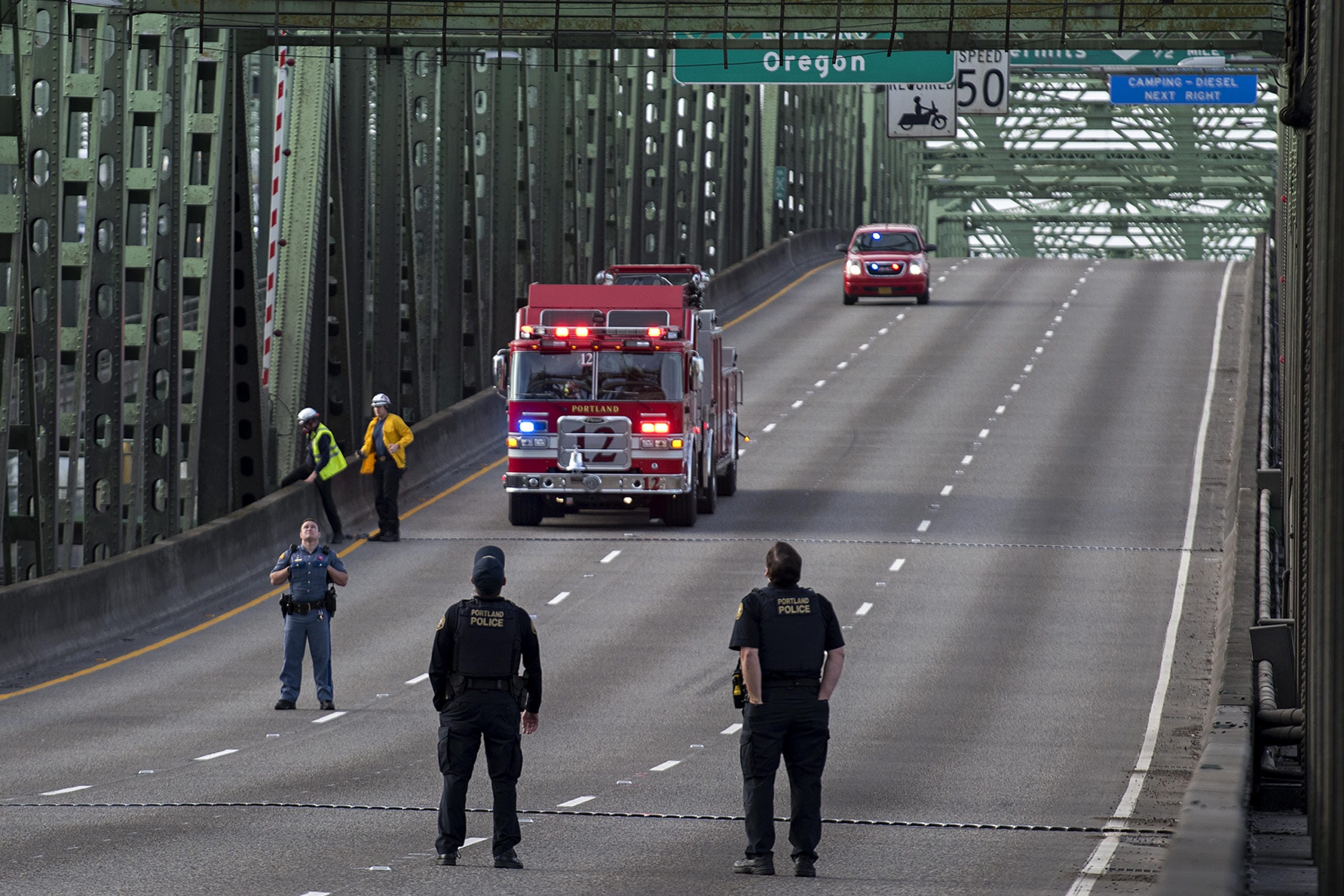 First responders keep an eye on the scene as police work on the Interstate Bridge as lanes are cleared of traffic on Tuesday morning, Oct. 20, 2020.