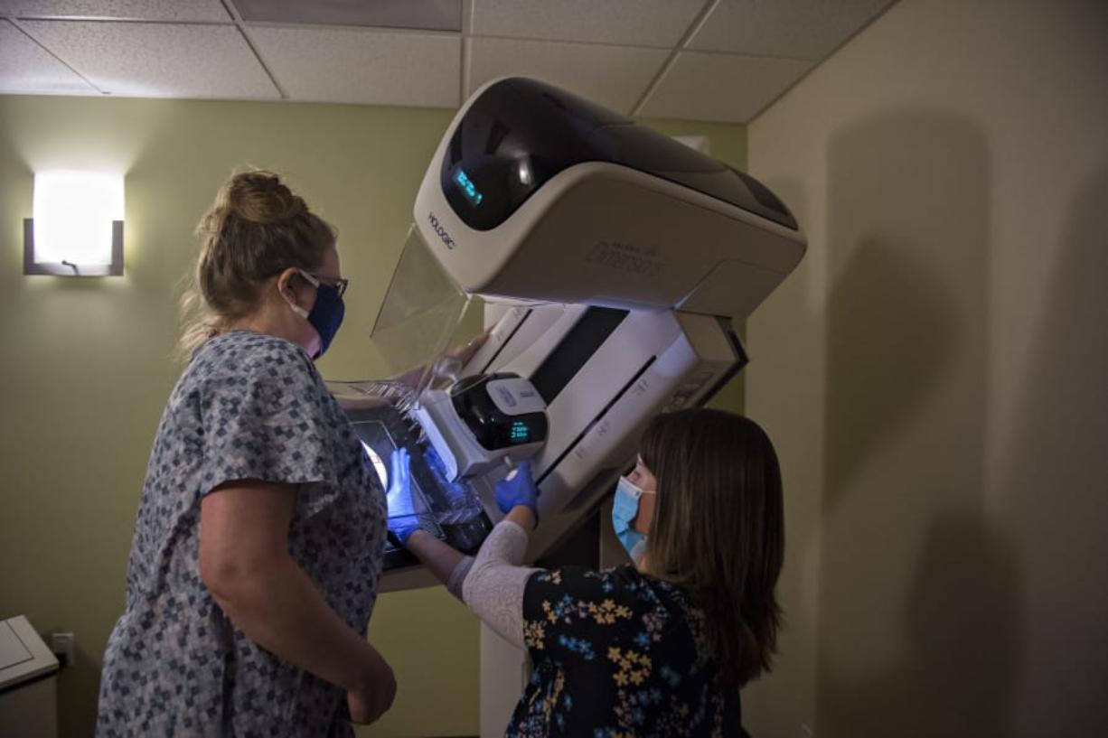 Amy Libby, The Columbian&#039;s web editor, gets assistance from radiological technologist Jenni Barr while getting her first mammogram at Kaiser Permanente&#039;s Cascade Park office in August.